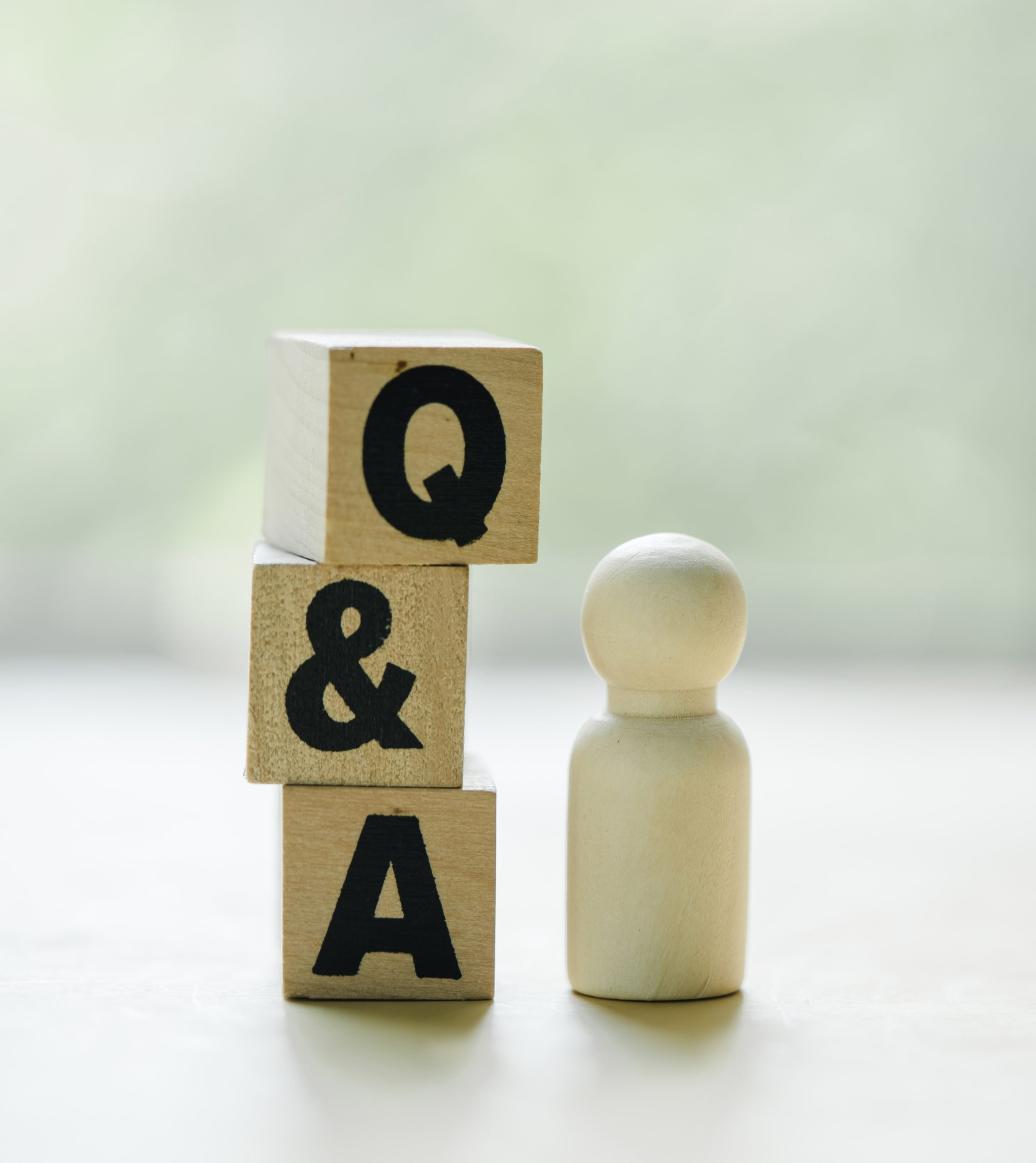Wooden blocks with the word FAQ, acronym frequently asked questions.